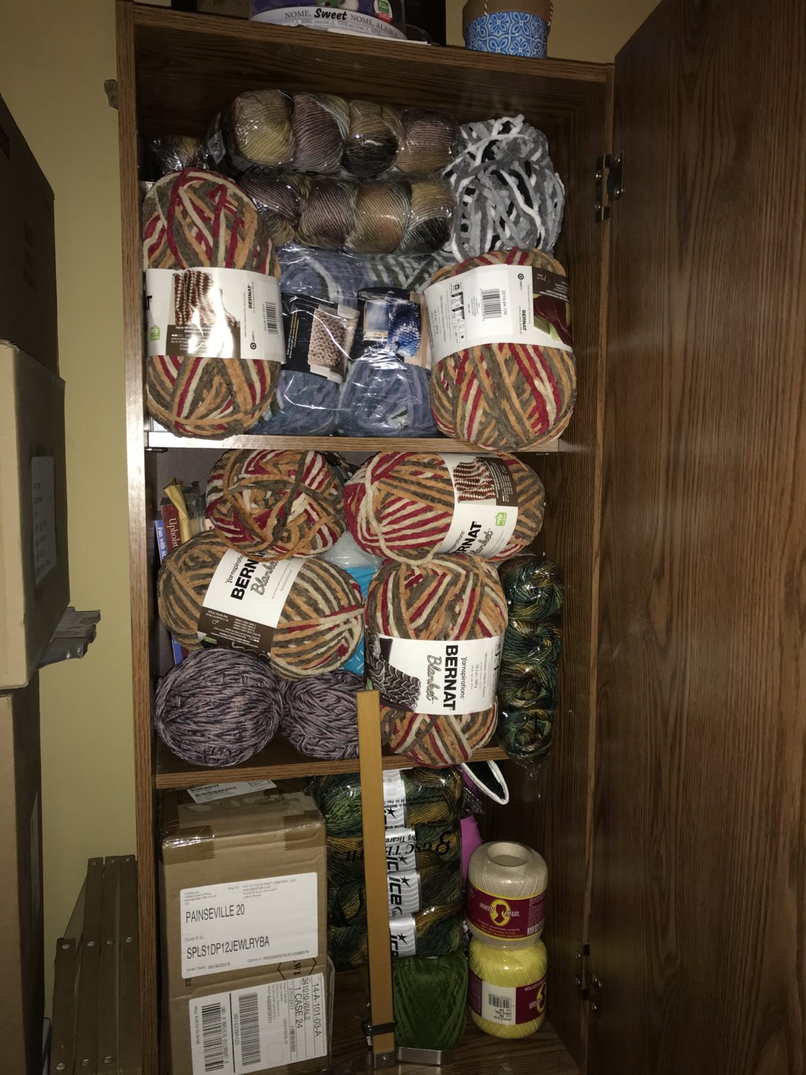 large floor cabinet filled with yarn