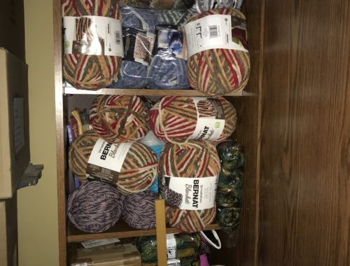 large floor cabinet filled with yarn